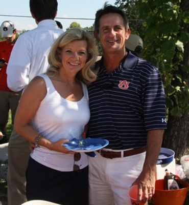 A couple in Auburn colors at a University Station cookout